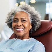 Smiling, mature woman in dental treatment chair