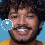 Smiling young man with a dental implant