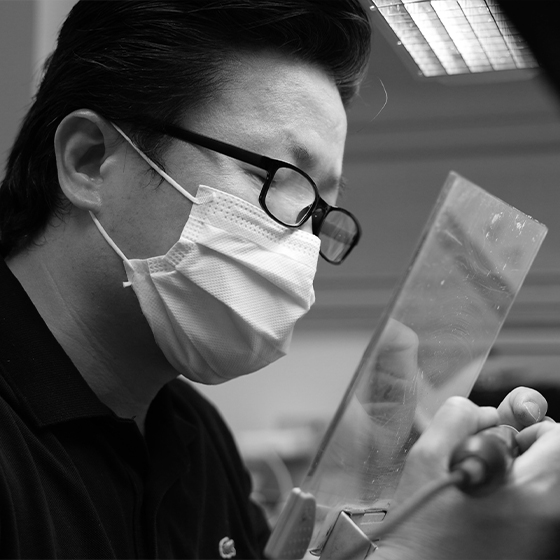 Ceramist crafting a dental crown in Boston