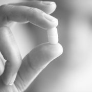 Close up of hand holding a pill