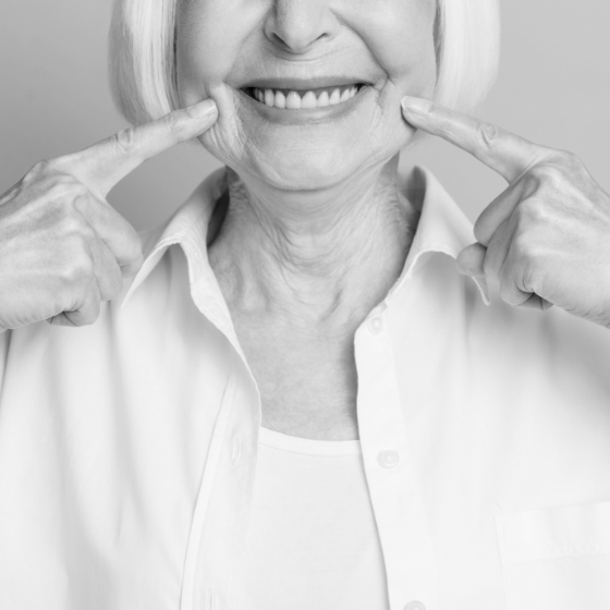 Senior woman pointing to her smile