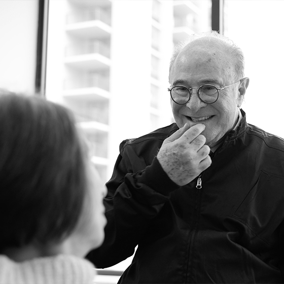 Dentist smiling while talking to a patient