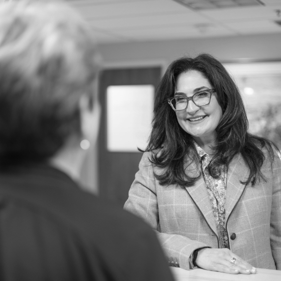 Woman smiling at dental office receptionist