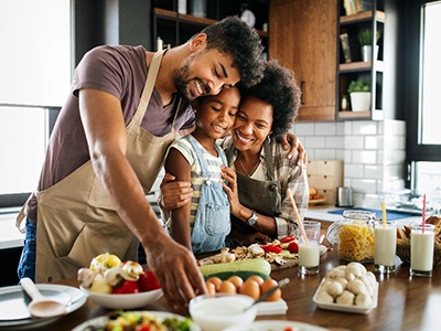 Dental implant patient in Boston eating healthy food with family