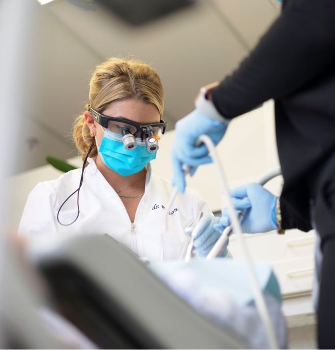 Boston dentist and assistant treating a patient