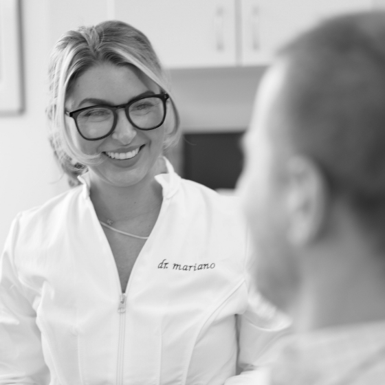 Doctor Mariano smiling at a dental patient