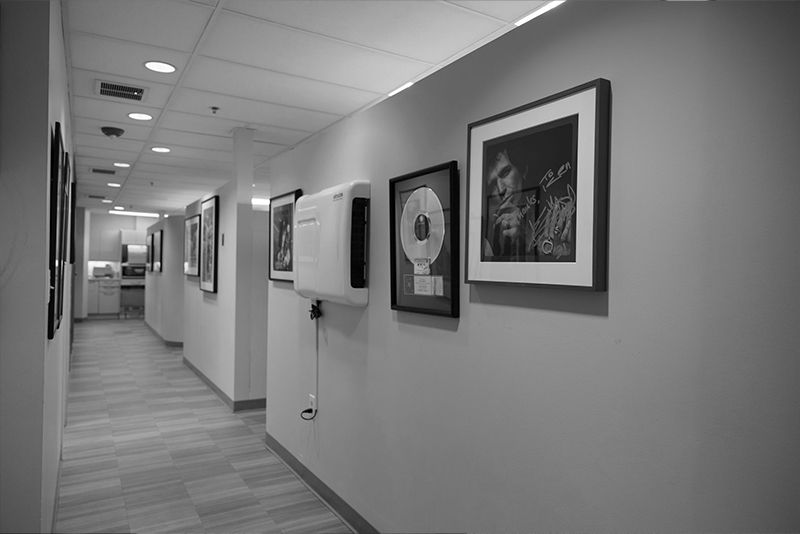 Hallway with framed autographed photos on wall