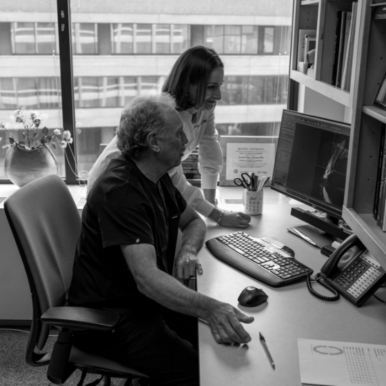 Two dentists looking at computer screen to plan placement of dental implants in Boston