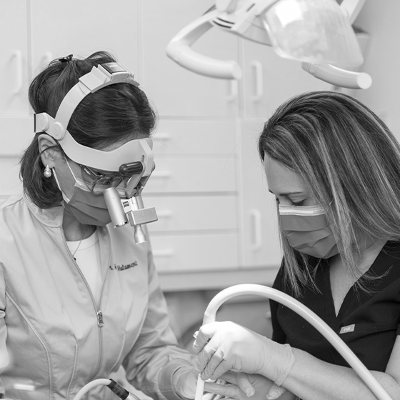 Dentist and assistant treating a patient with restorative dentistry in Boston