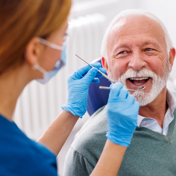 Man smiles at dentist