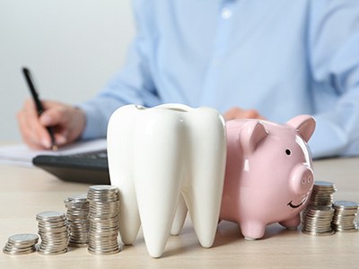 Coins next to a piggy bank